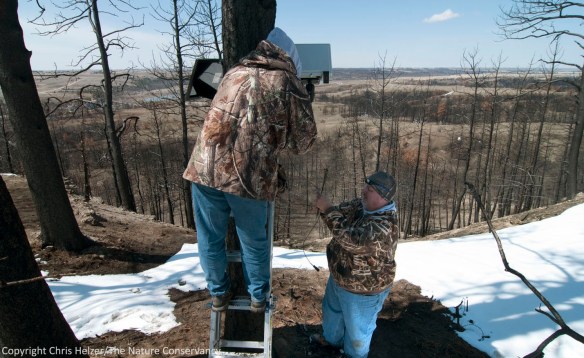 Jeff Dale and David Weber install a camera that will look straight down a steep slope in the burned pine woodland on the ridge north of the river. Among other things, this camera will help capture evidence of any soil erosion that occurs over time.