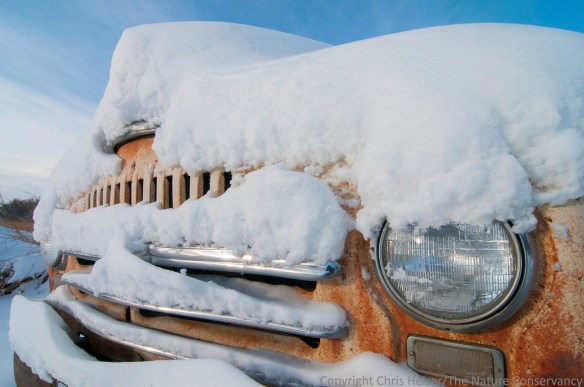 An old truck in a snowy prairie.  Leadership Center Prairie - Aurora, Nebraska.