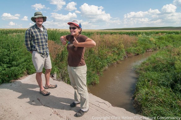 Hubbard Fellows Dillon Blankenship (left) and Jasmine Cutter stand near an irrigation ditch during a tour of Platte River irrigation activities.