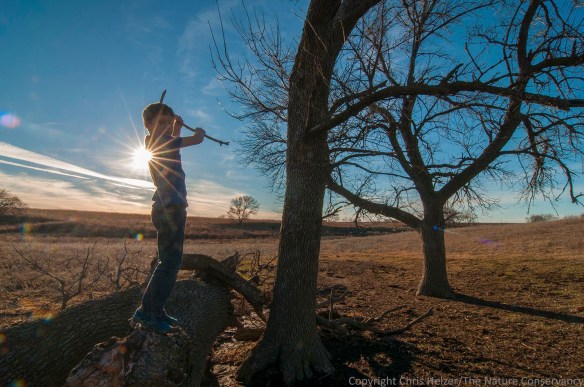 Boy with sticks. Helzer family prairie, Nebraska. Calvin Miller (Photographer's stepson)